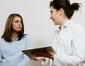 female medical worker talking to female patient